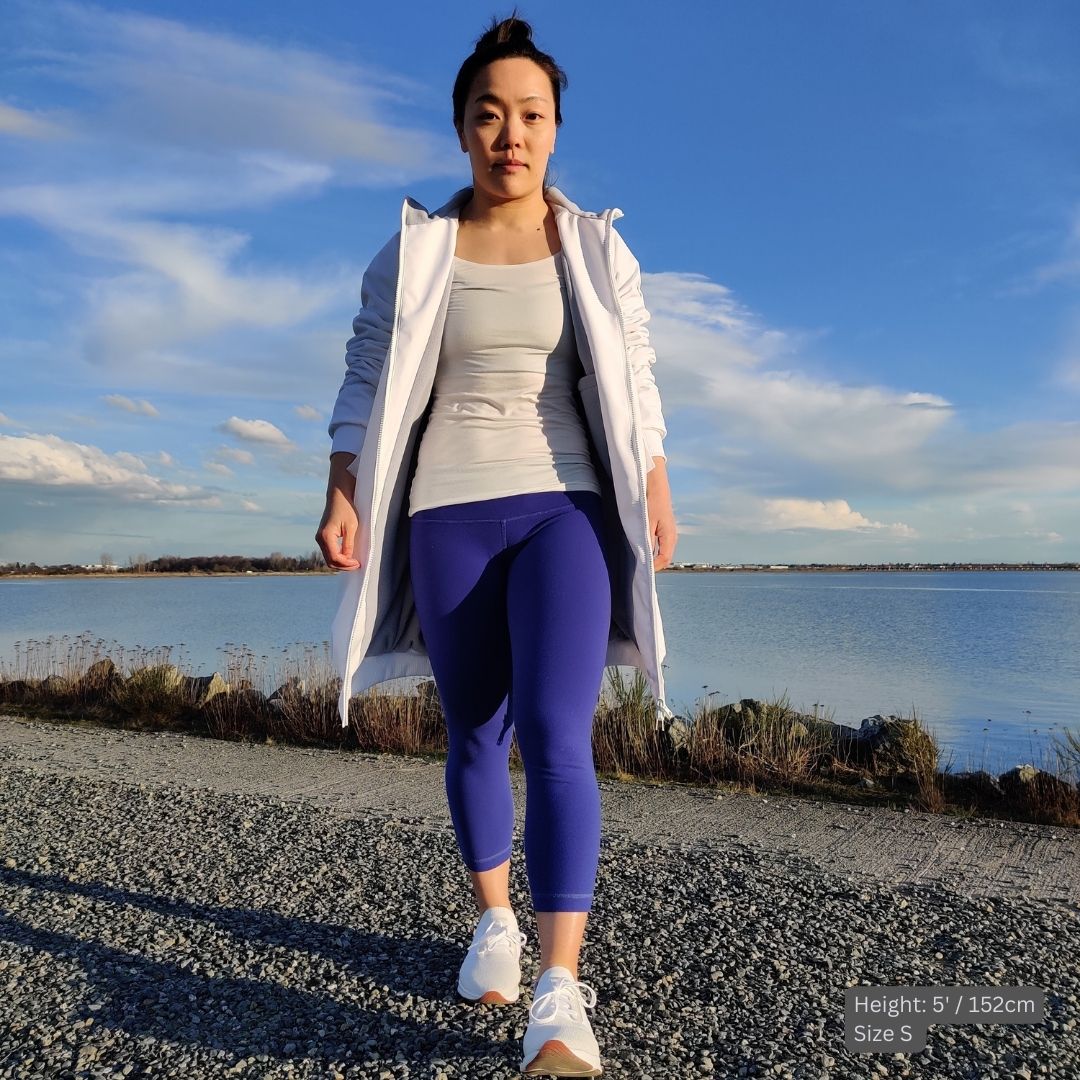 Swimmer (5' tall) wears a white swim parka in small size over a fitted white t-shirt and blue tights