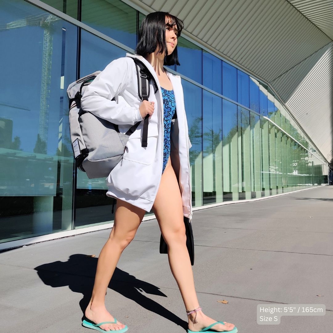 Female swimmer wears a swim parka to swim practice