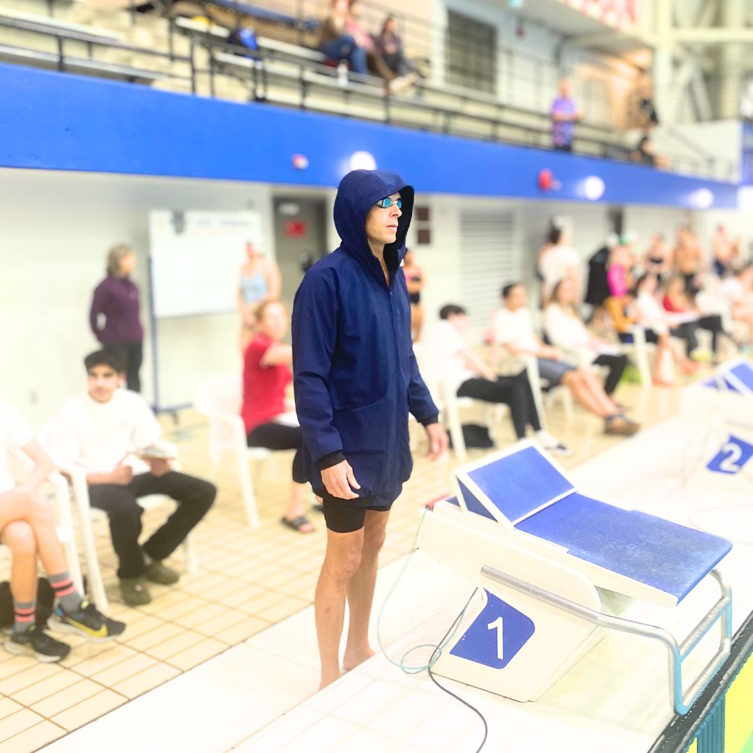 Male swimmer in a swim parka before a race
